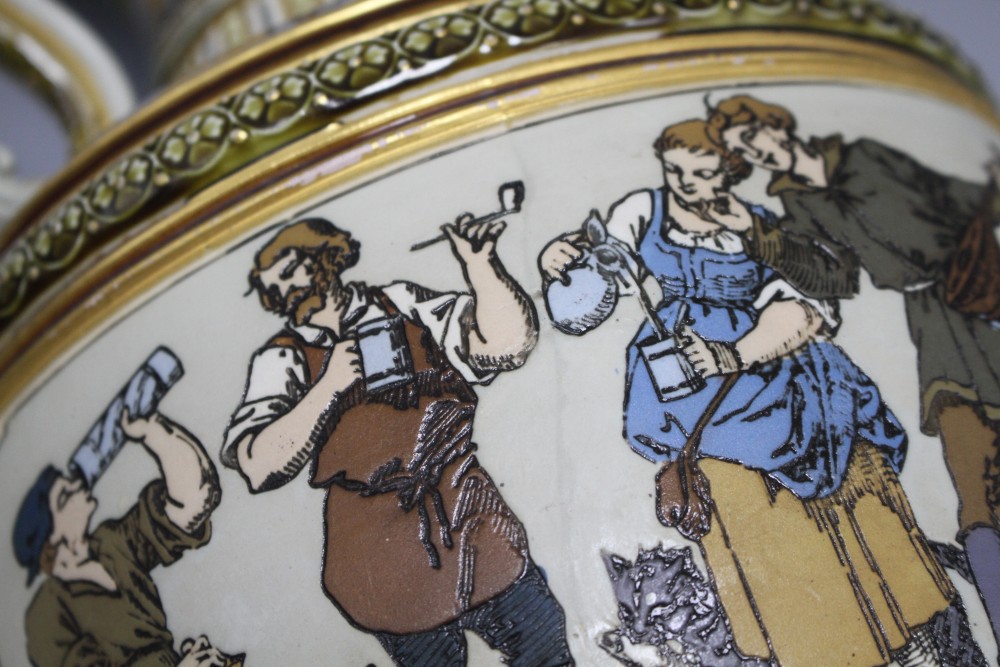A large Villeroy and Boch Mettlach ewer, decorated with figures drinking, dancing and musicians, impressed 1159, height 45cm